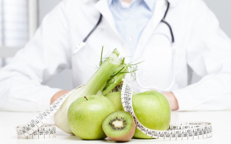 Nutritionist Doctor is writing a prescription. Focus on fruit